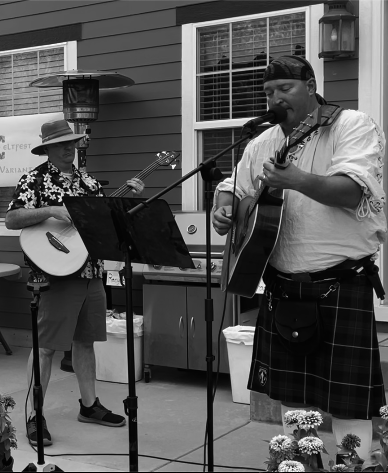 Eric and Nick playing an acoustic set in black and white